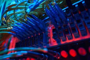 IT professional performing routine server maintenance in a modern data center to improve system reliability and business performance.