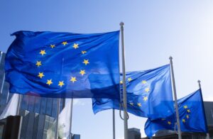 European Union flags at La Defense in Paris, representing NIS2 compliance rules for European businesses