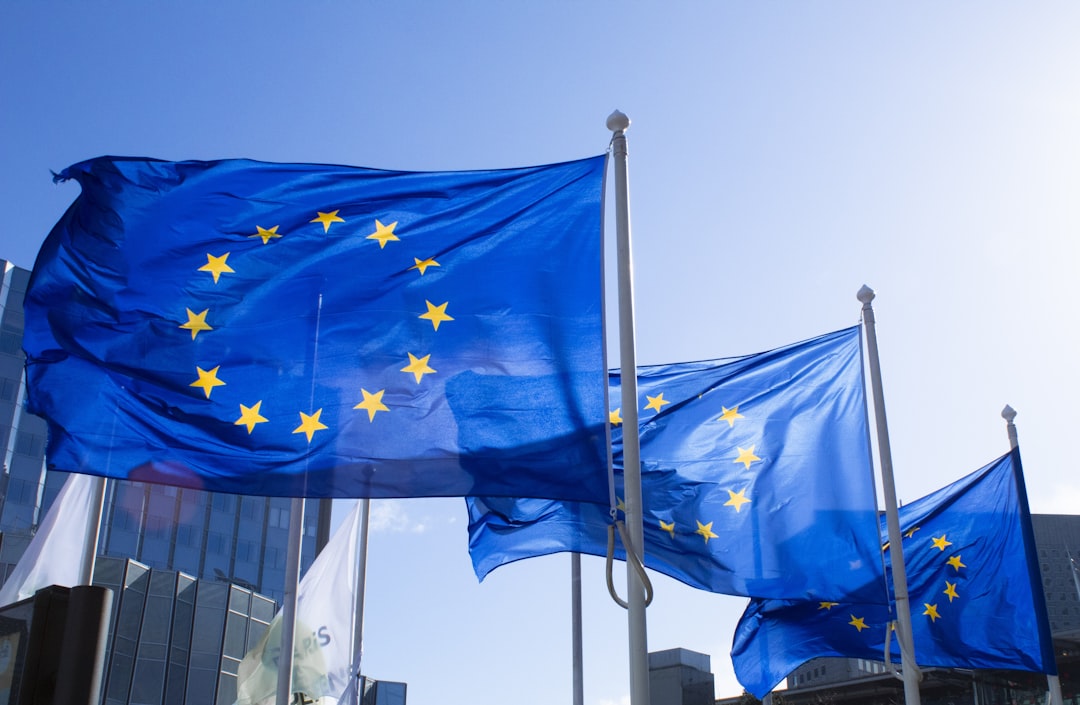 Európai Uniós zászlók a párizsi La Defense-ban, amelyek az európai vállalkozásokra vonatkozó NIS2 megfelelőségi szabályokat képviselik