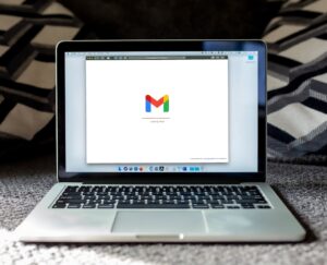 MacBook laptop on a black surface, the everyday device where email authentication protects business mail